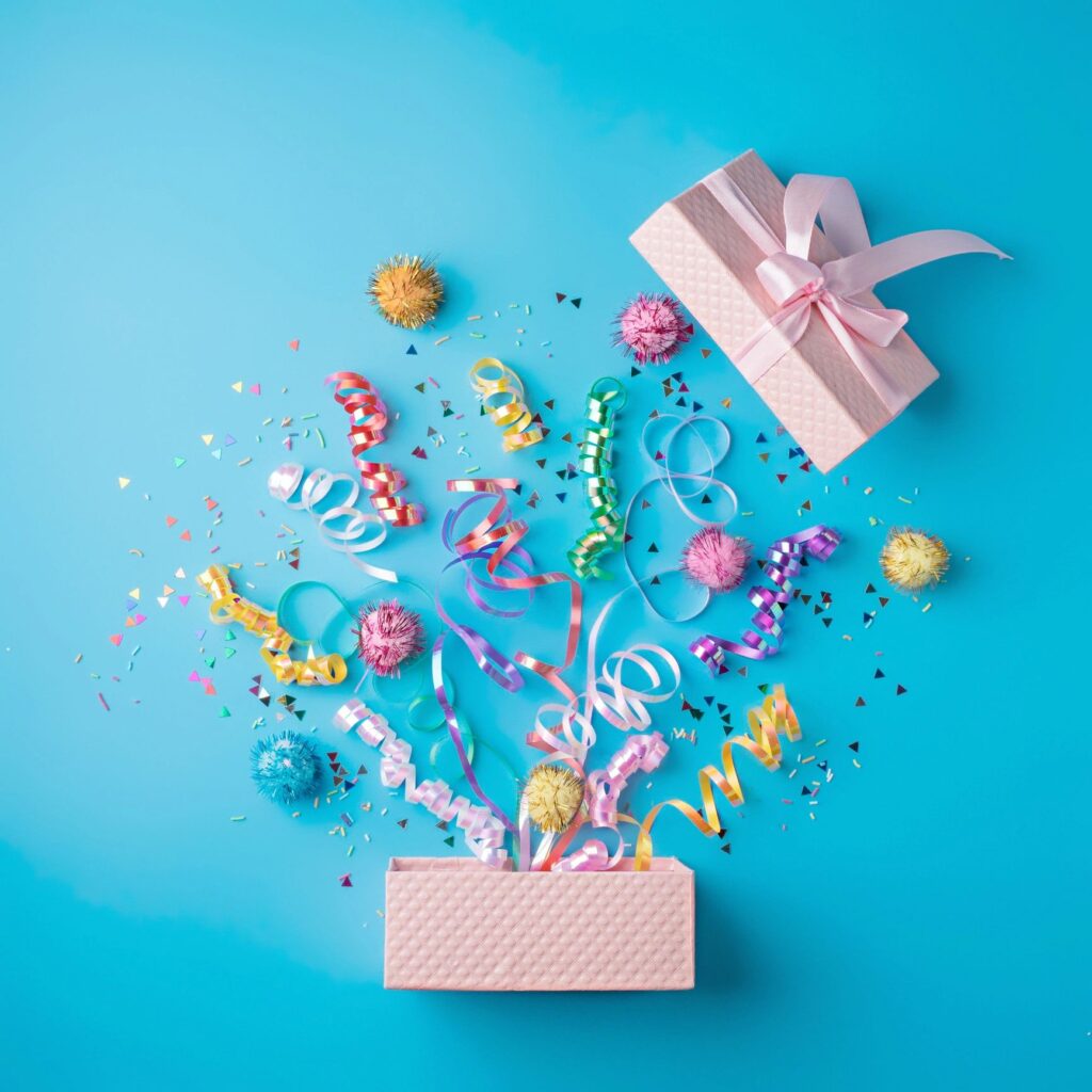 Flat-lay party bundle with assorted snacks and sparkling alcohol-free drinks on a clean background