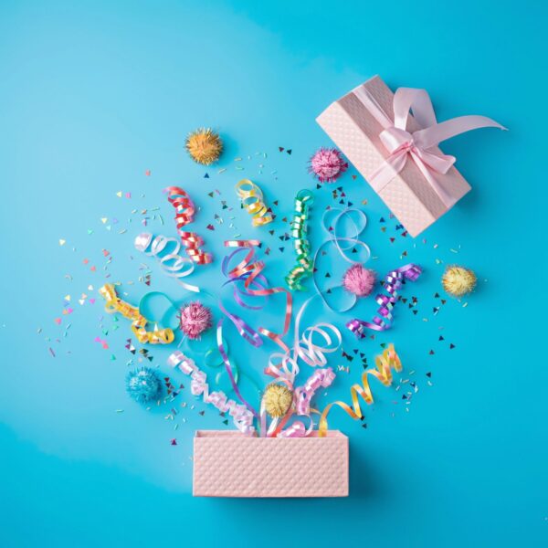 Flat-lay party bundle with assorted snacks and sparkling alcohol-free drinks on a clean background