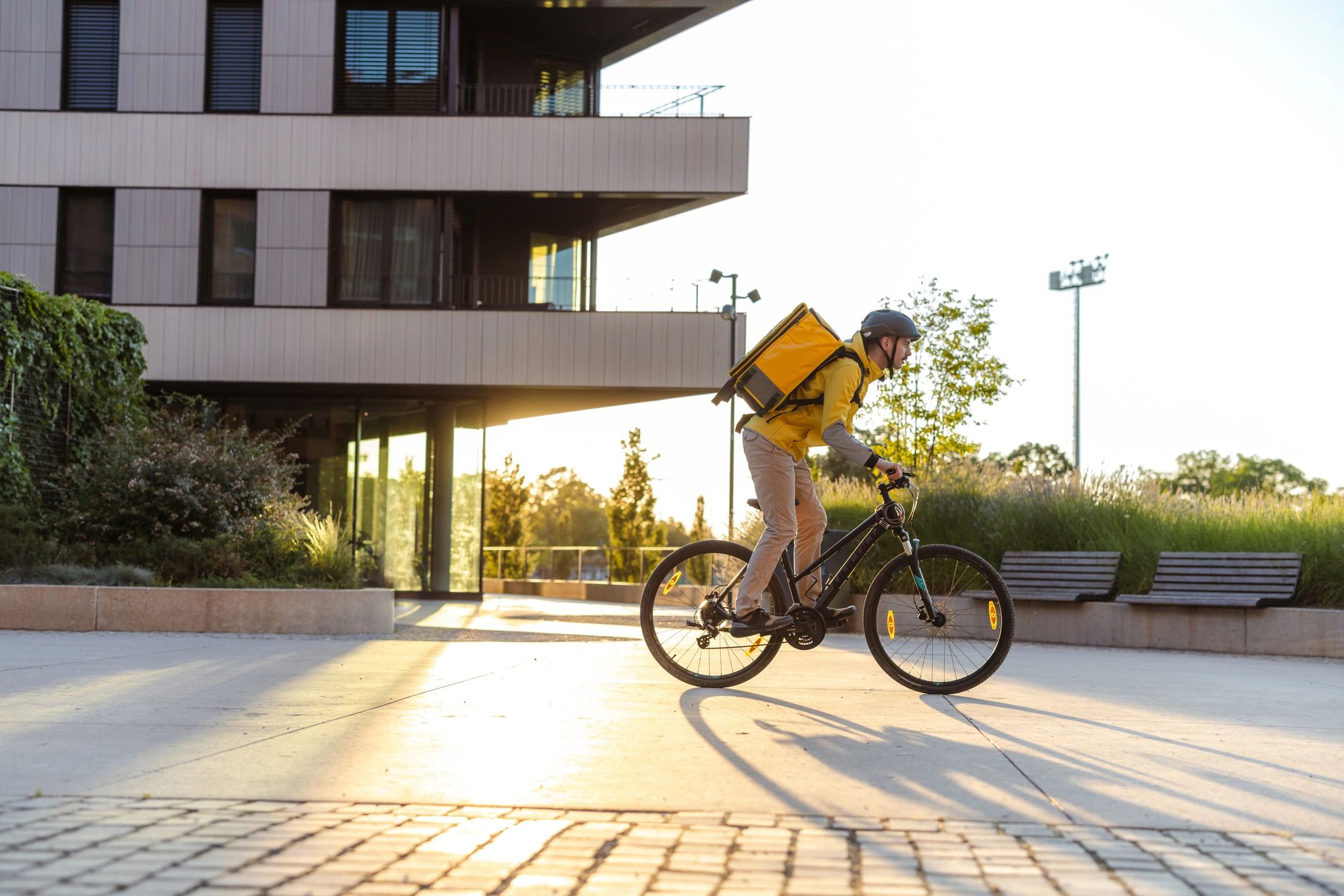 Delivery person riding a bicycle in an urban area