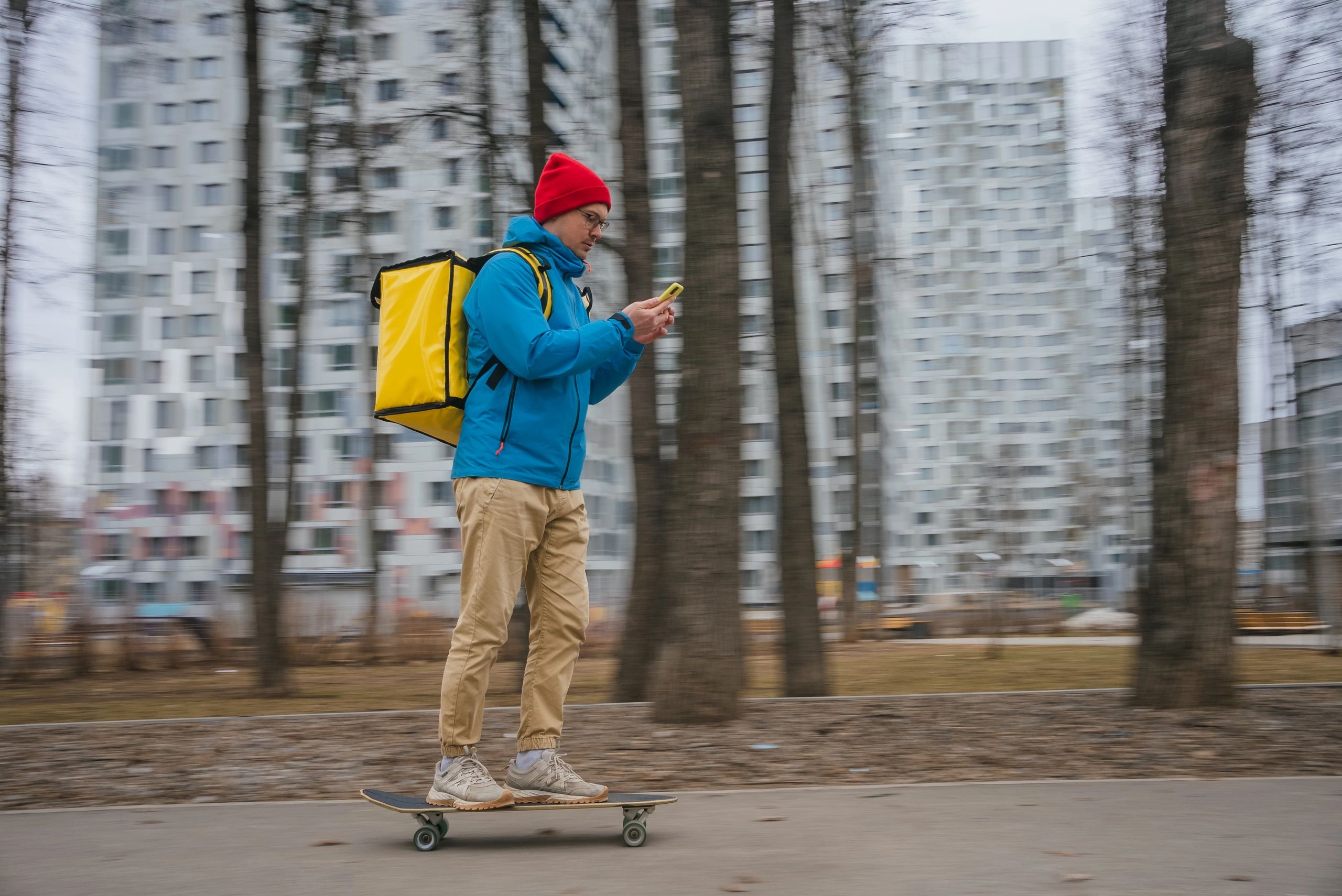 Delivery courier using a smartphone app while riding through the city